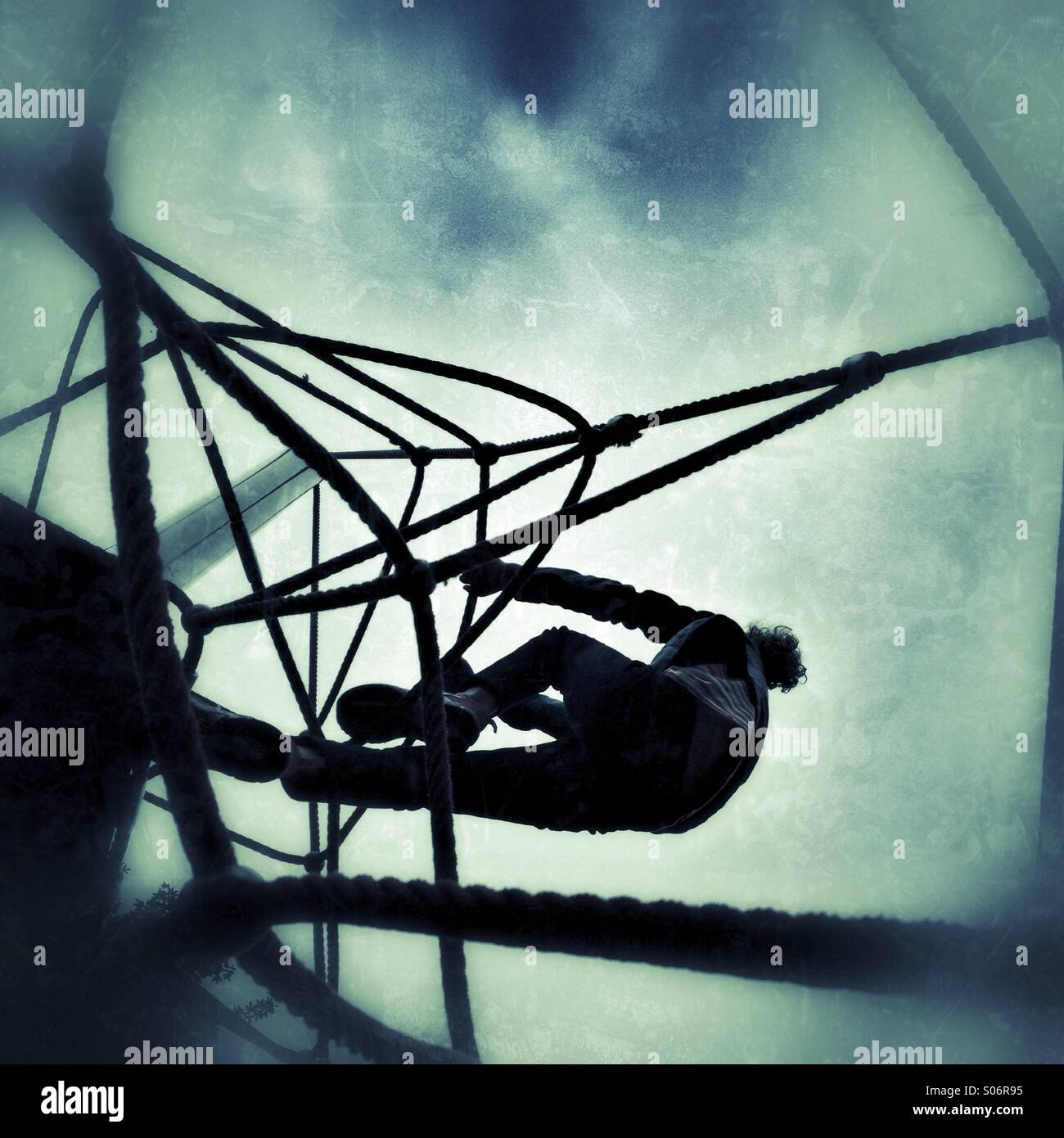 Girl climbing rope climbing frame Stock Photo Alamy