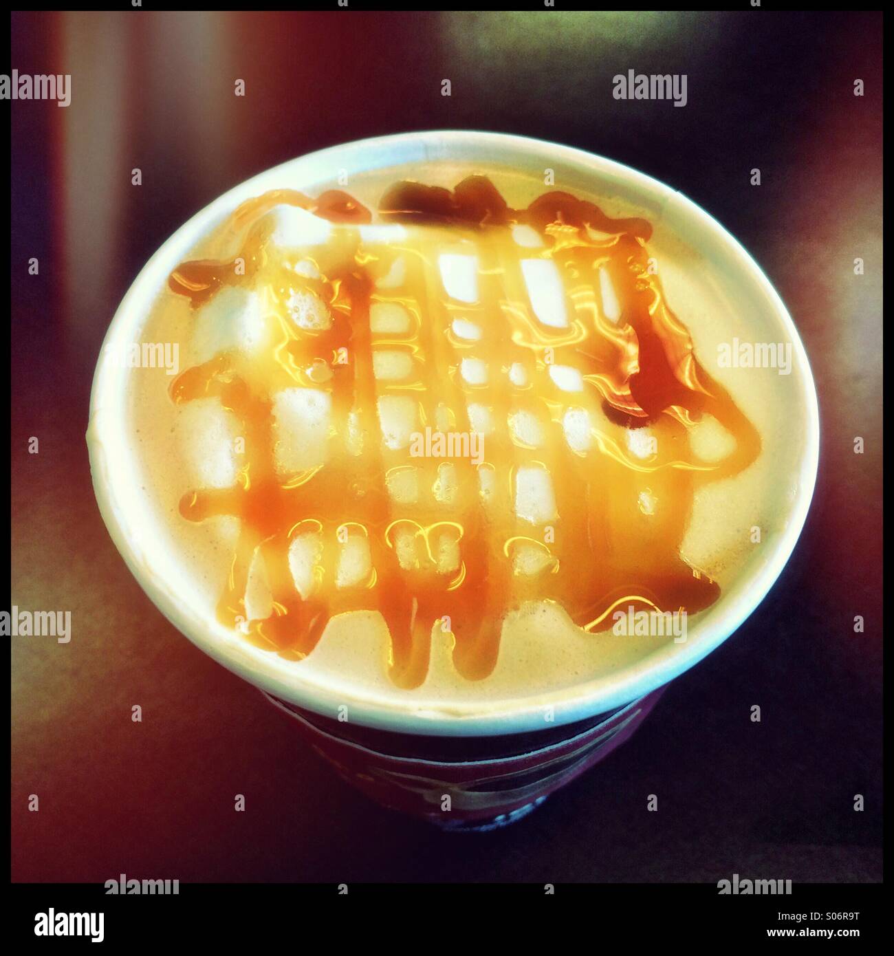 Caramel latte coffee in a disposable cup. - Smartphone Captured Stock Image