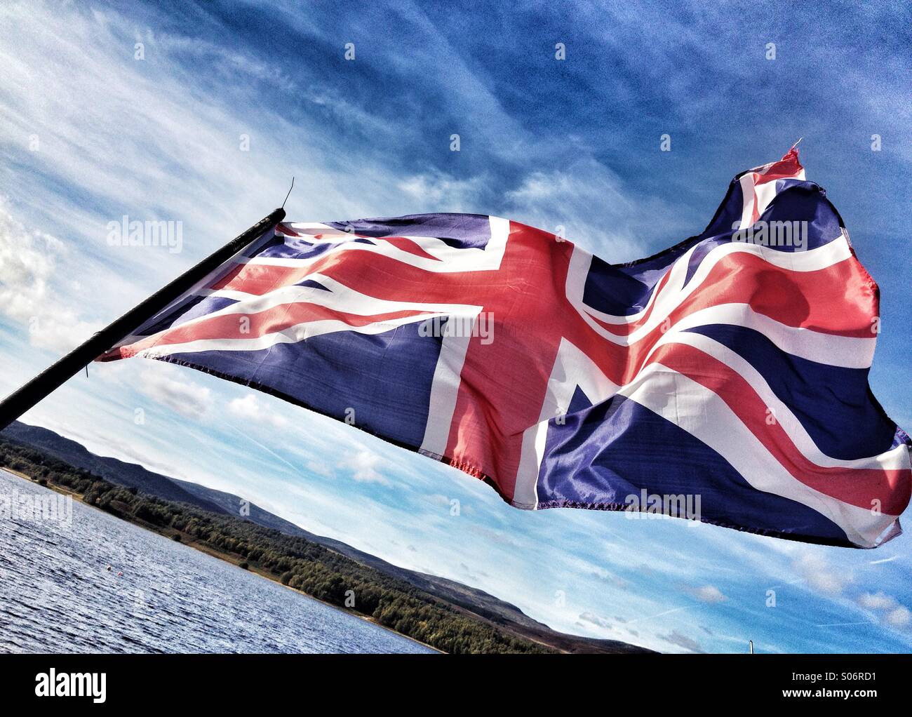 The Union Flag Jack of the United Kingdom fluttering in the breeze. Horizontal format. - Smartphone Captured Stock Image