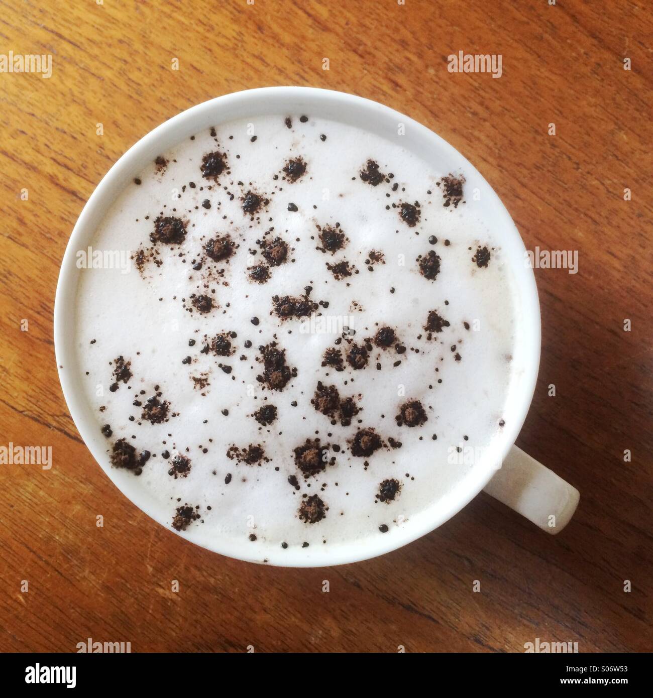Latte coffee with cocoa sprinkles. - Smartphone Captured Stock Image
