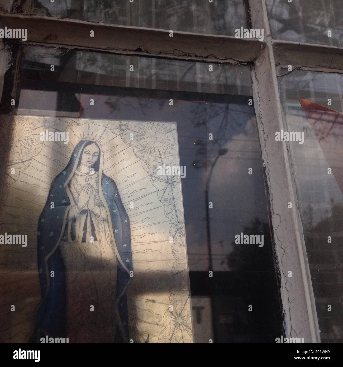 An image of Our Lady of Guadalupe decorates a window in Colonia Roma, Mexico City, Mexico Stock Photo