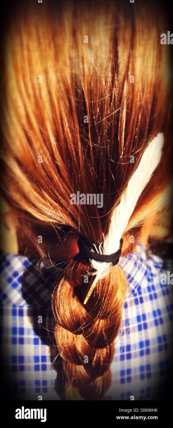 Girl in a school uniform with a feather in her hair. - Smartphone Captured Stock Image