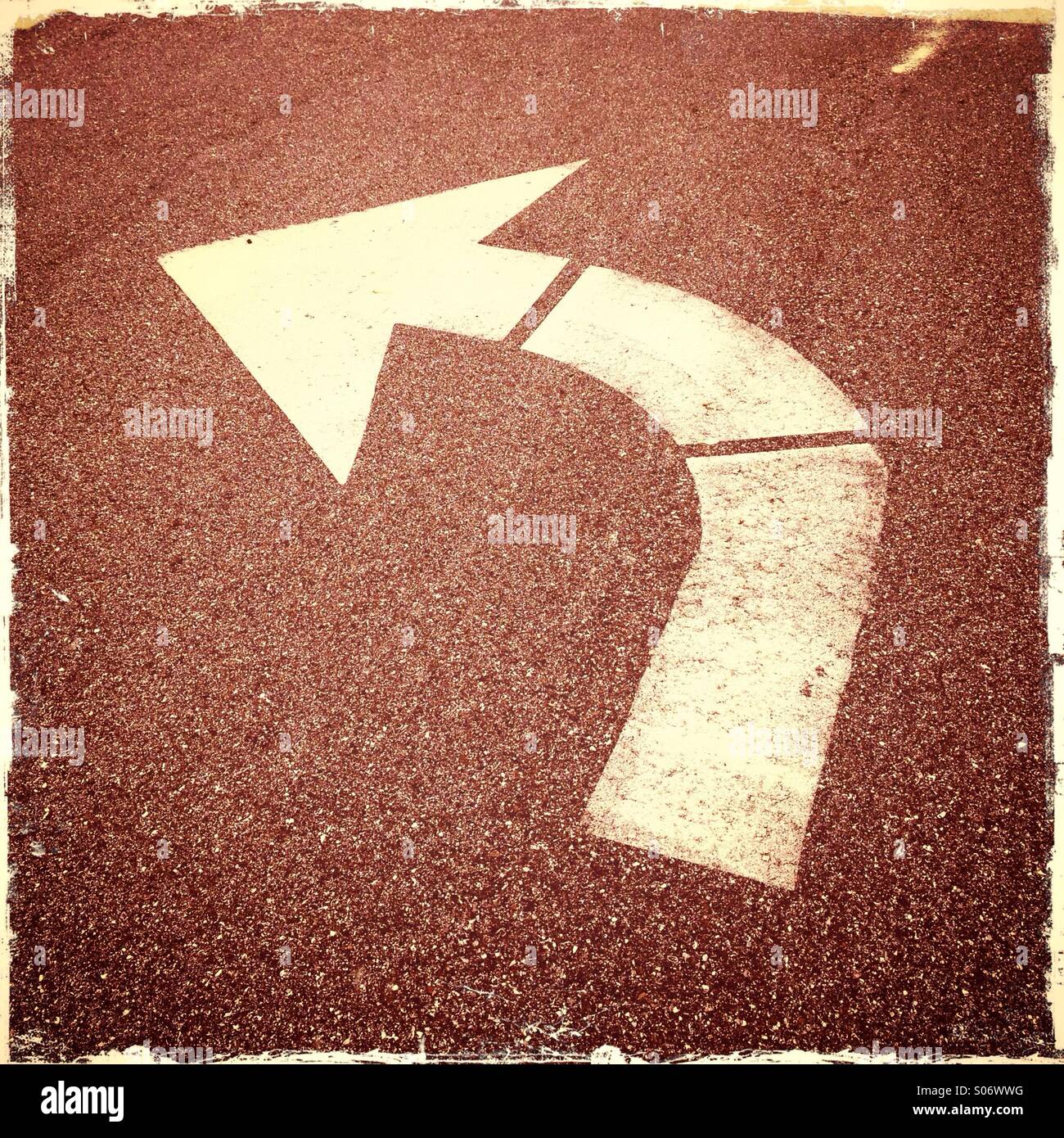An arrow in the street indicating a turn lane. Stock Photo