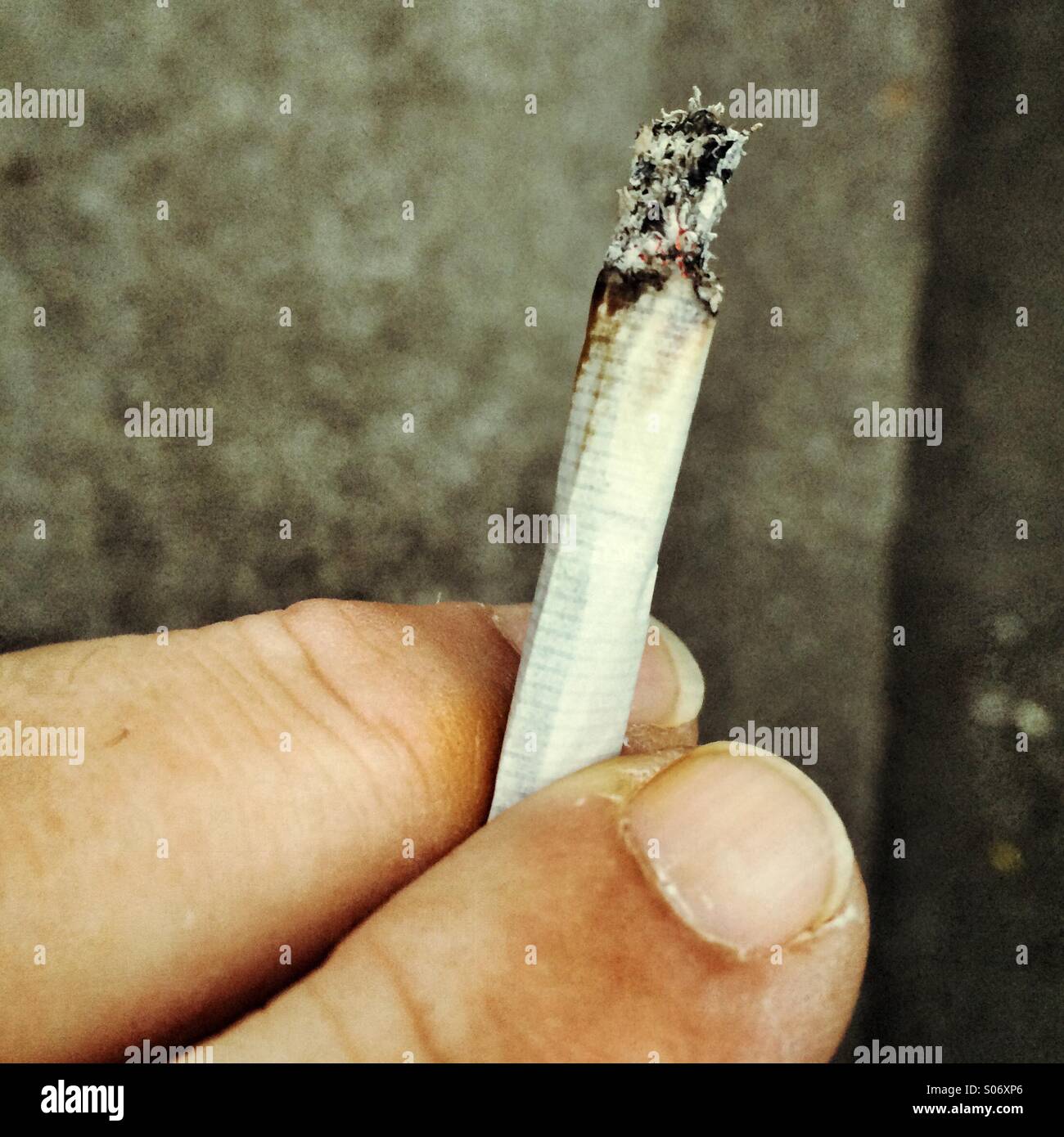 Smoking a roll up cigarette Stock Photo