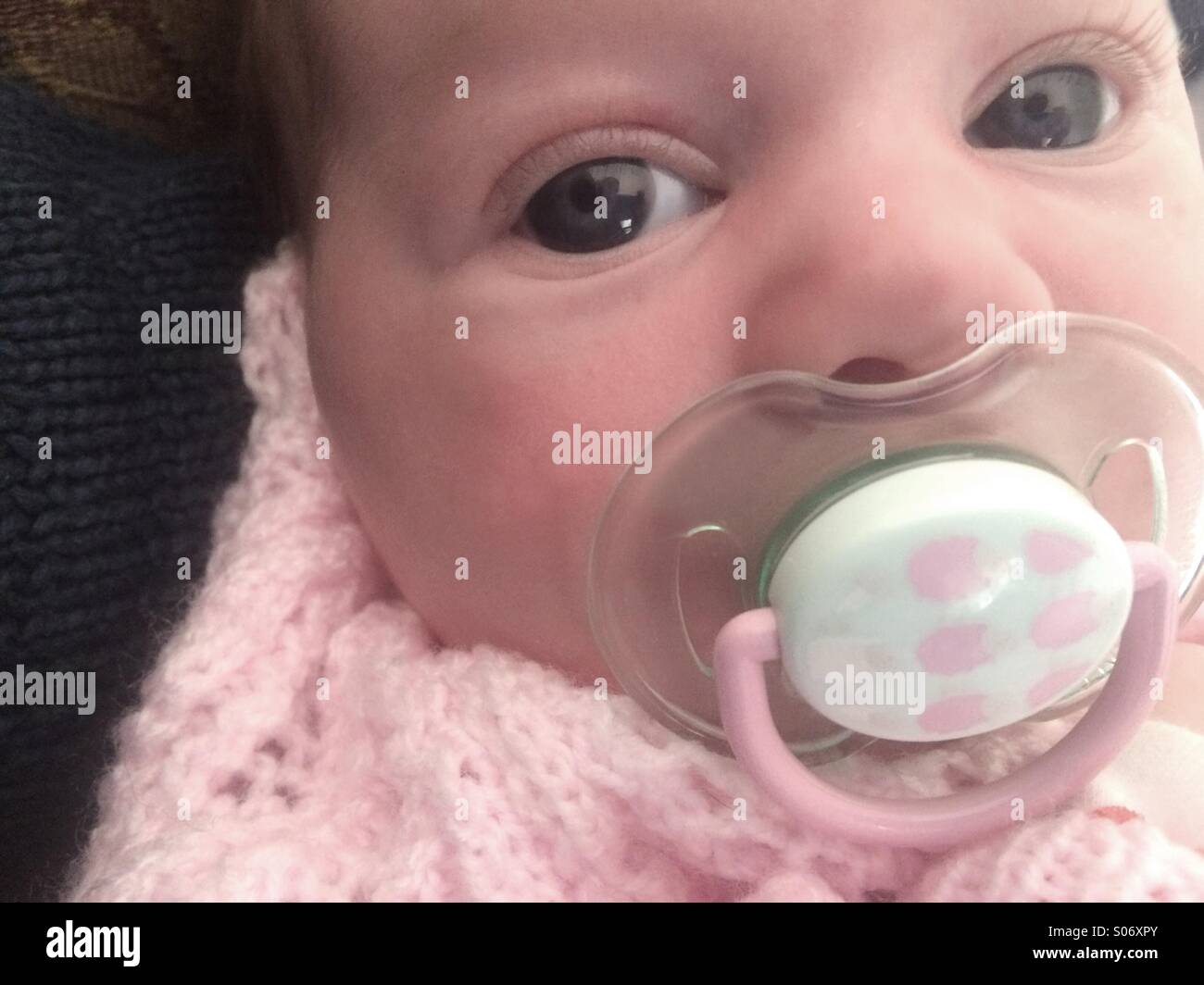 Tired baby with a dummy Stock Photo Alamy