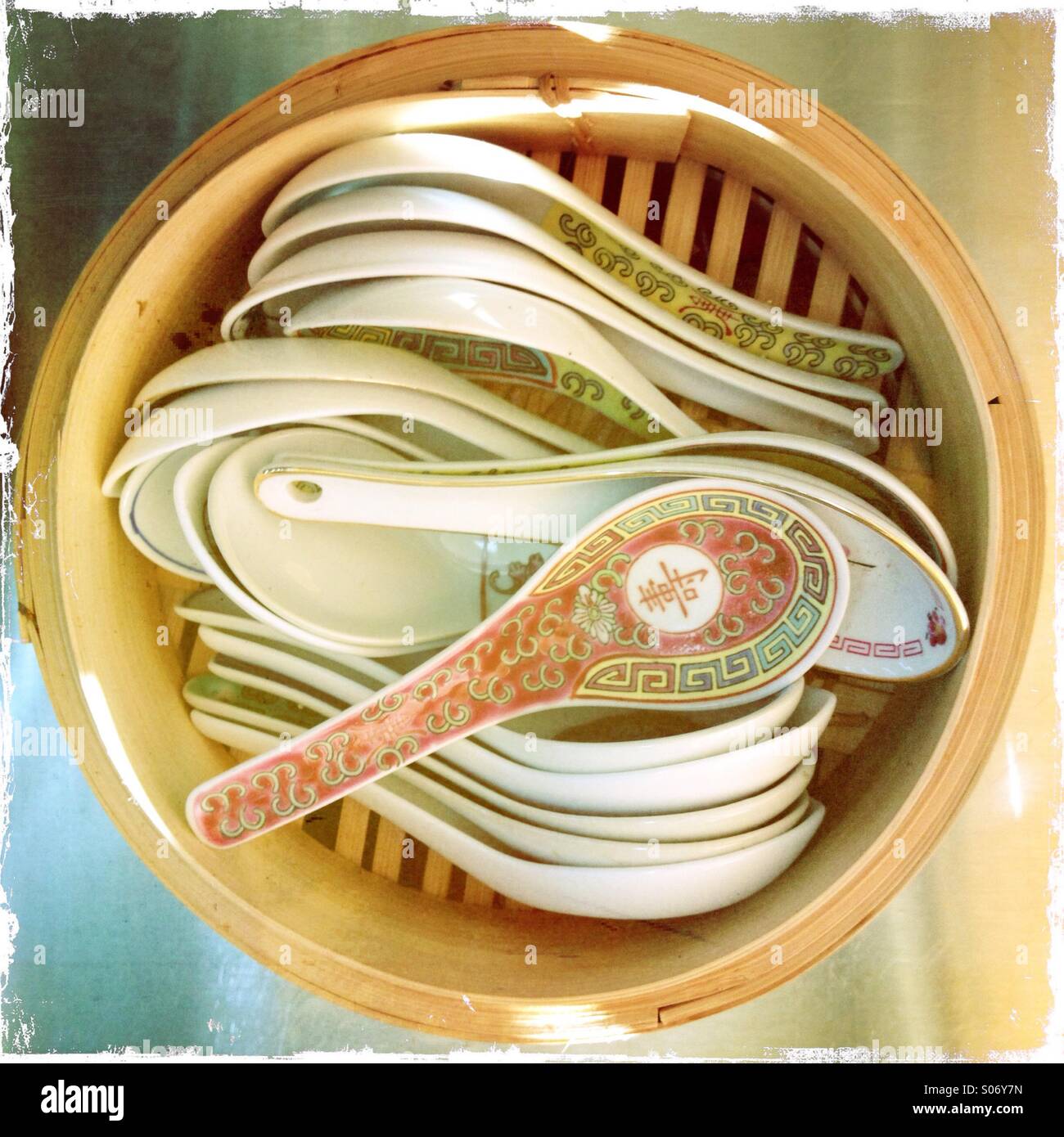 Chinese soup spoons stacked in bamboo rice steamer Stock Photo Alamy