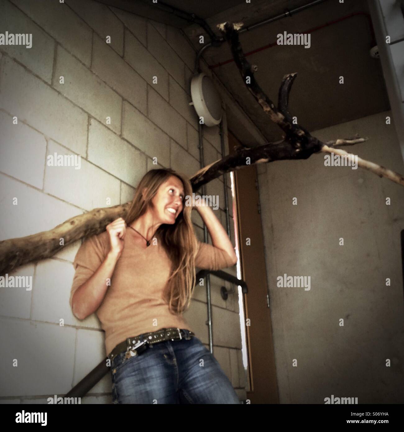 Women trying to lift a big piece of wood - Smartphone Captured Stock Image