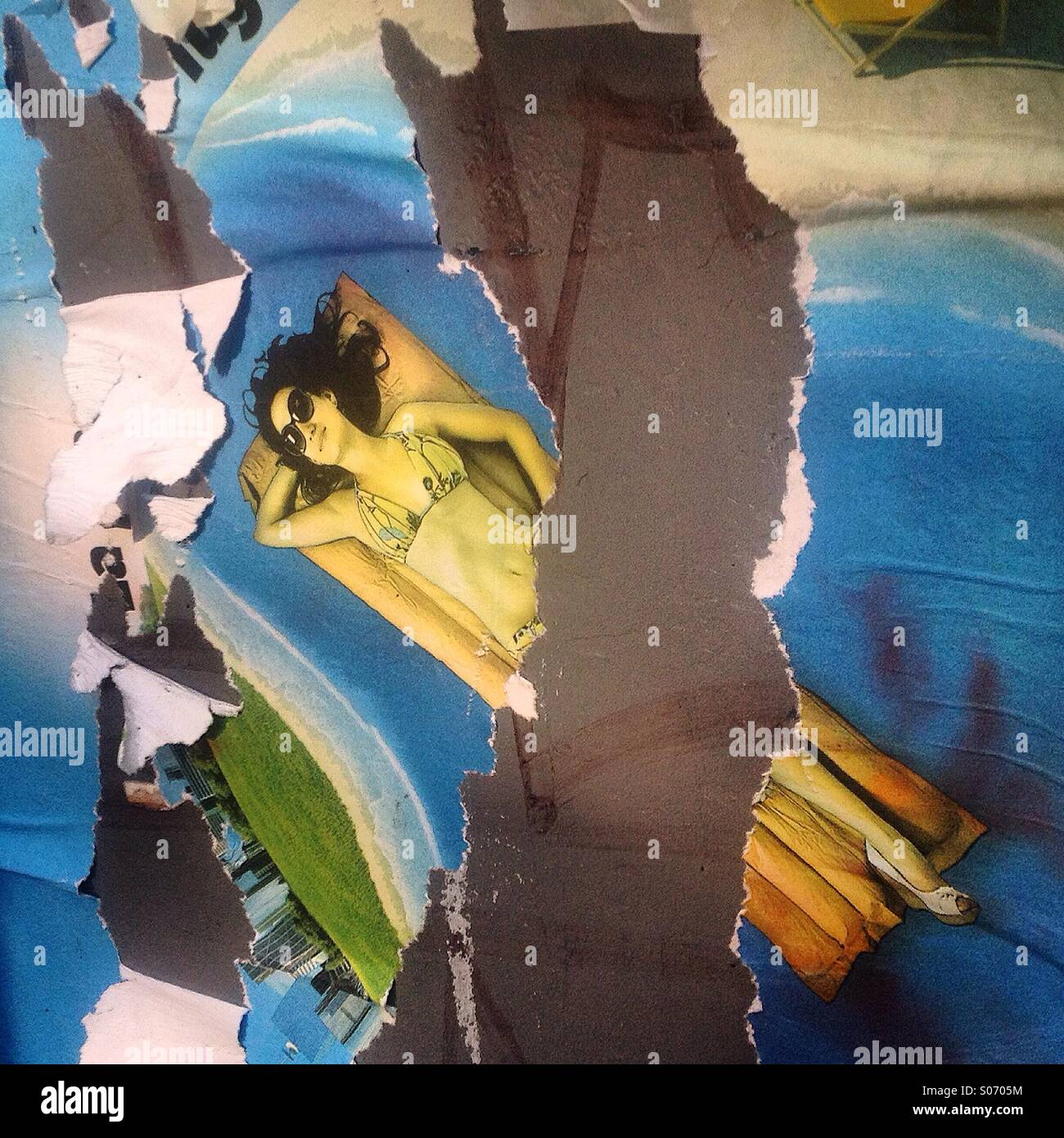 A broken advertising of a woman in bikini sunbathing decorates a wall in Colonia Condesa, Mexico City, Mexico - Smartphone Captured Stock Image