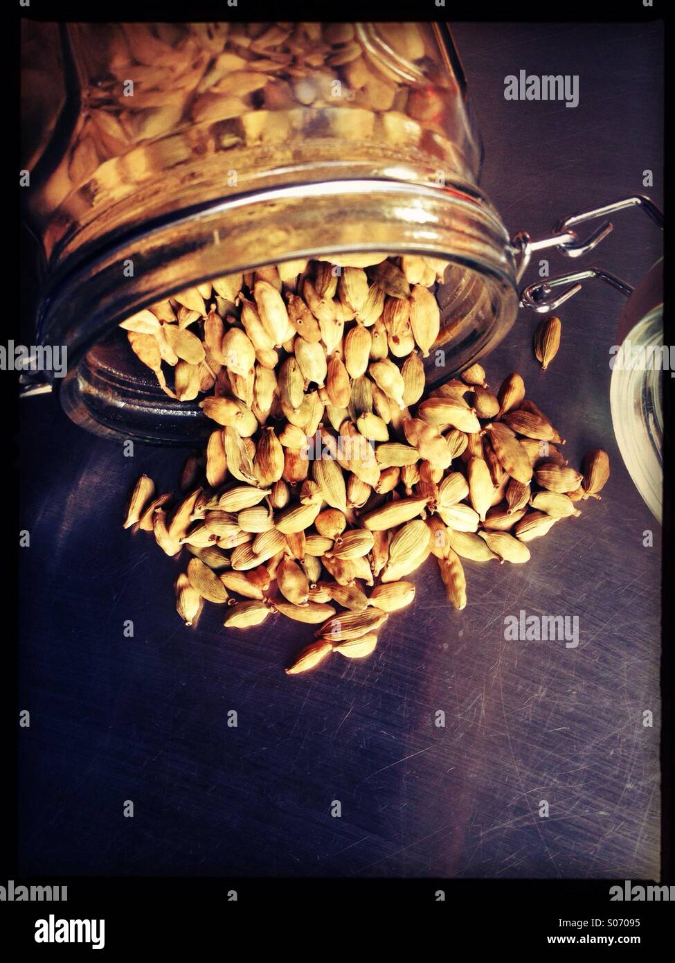 Green Cardamom pods spilling out of storage jar Stock Photo Alamy