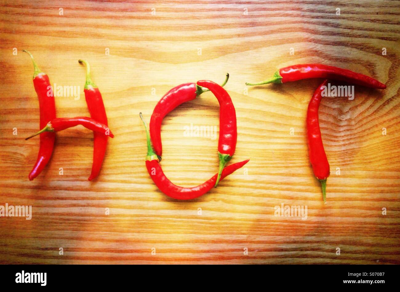 Chilli peppers spelling the word hot Stock Photo Alamy