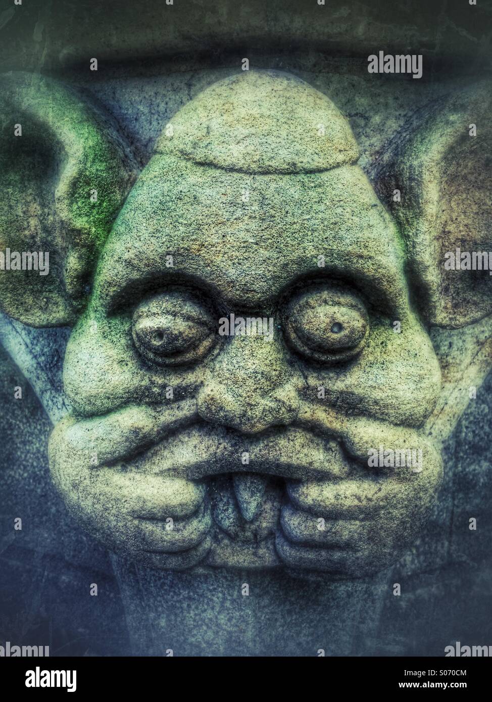 Stone carving of a Gargoyle pulling a face - Smartphone Captured Stock Image Stone carving of a Gargoyle pulling a face - Smartphone Captured Stock Image