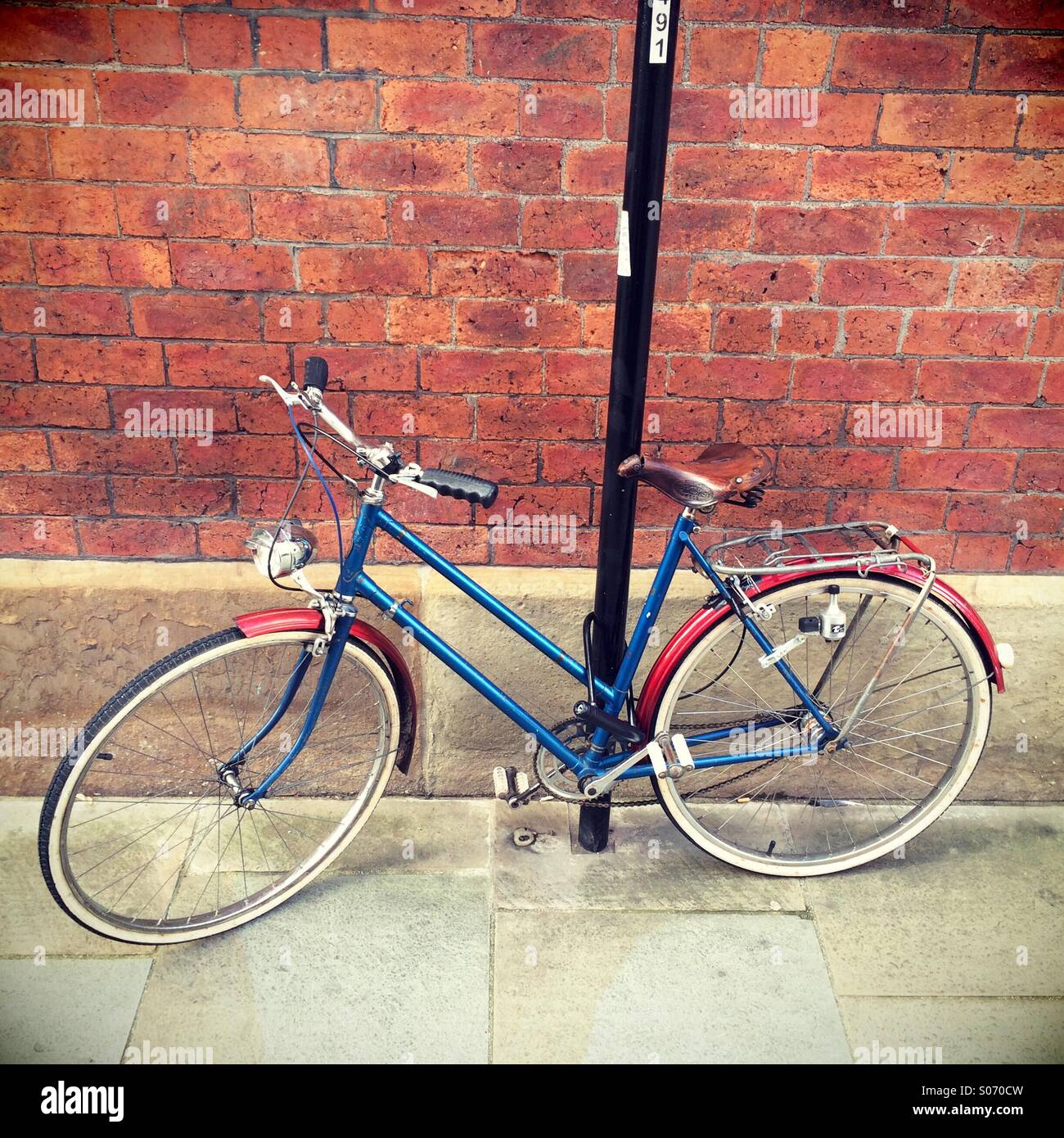 Old fashioned bicycle chained to a lamppost - Smartphone Captured Stock Image