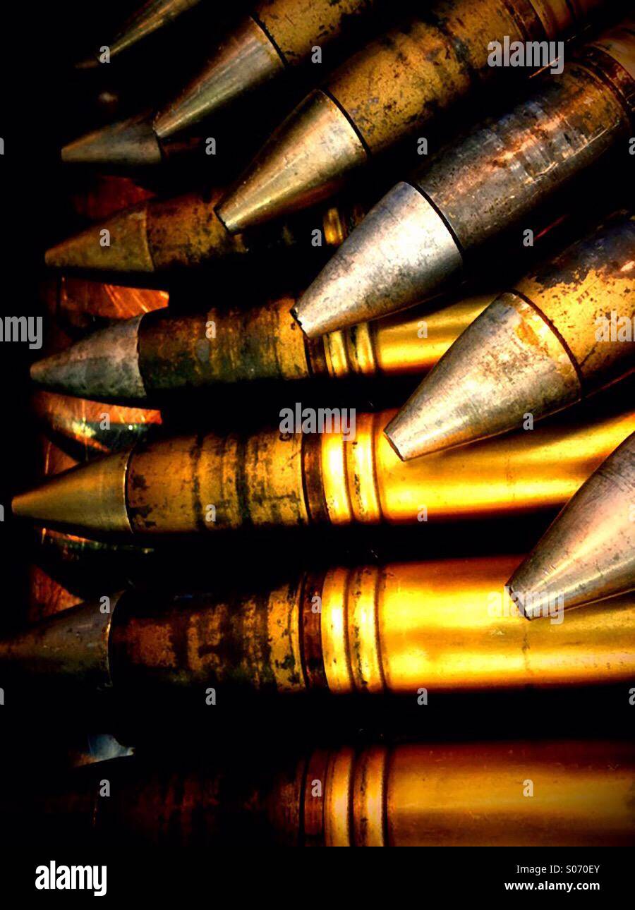Clips of 30mm ammunition rounds laying on top of each other. Stock Photo