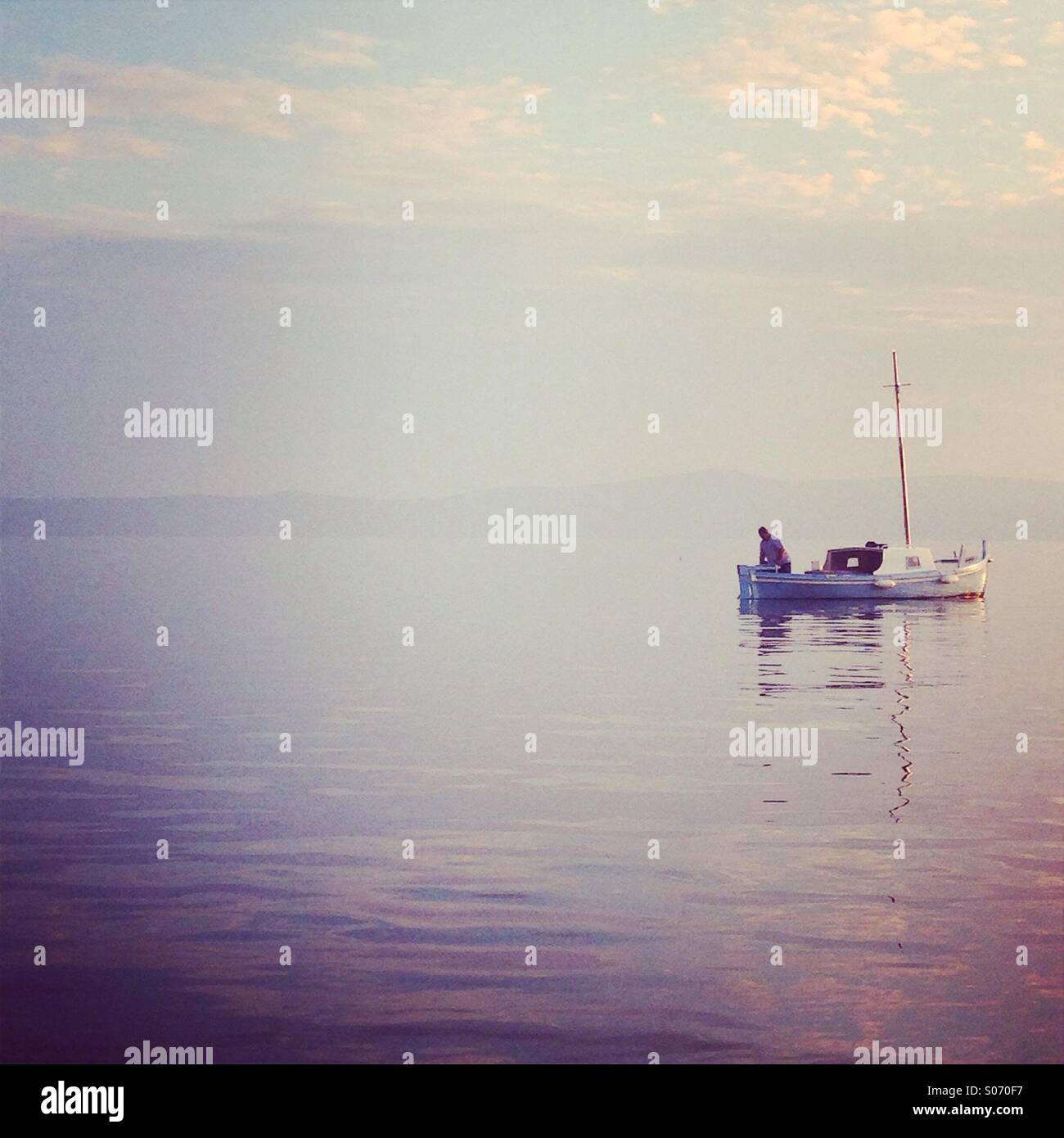 Fisherman on traditional wooden fishing boat Stock Photo
