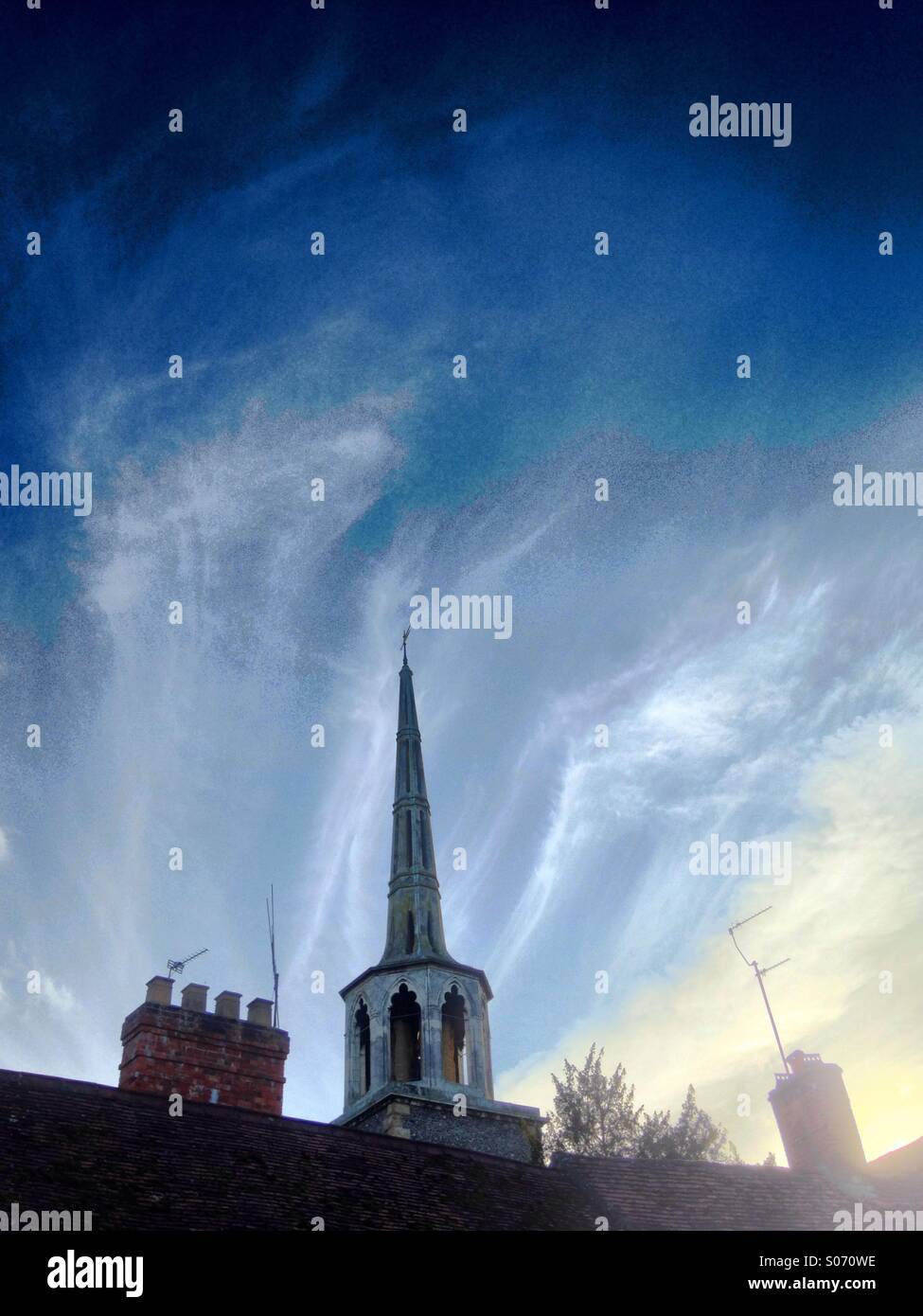 Church spire against dramatic sky Stock Photo