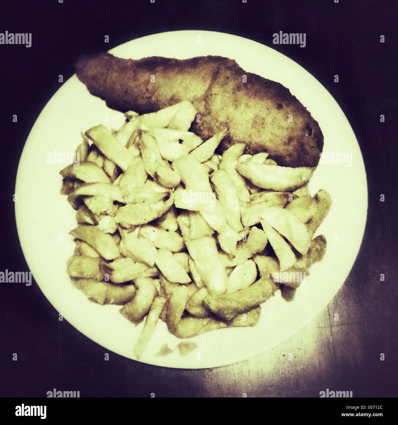 Traditional take away fish and chips on a white plate - Smartphone Captured Stock Image