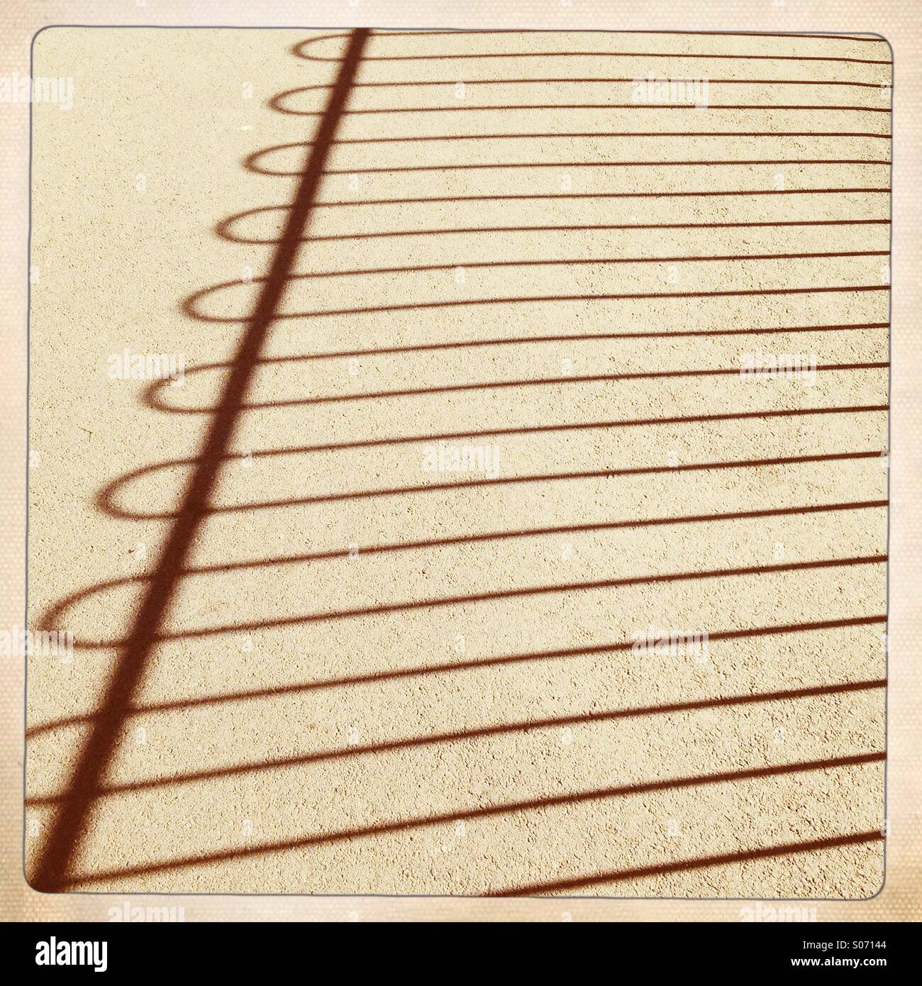 Shadow of a metal fence UK - Smartphone Captured Stock Image