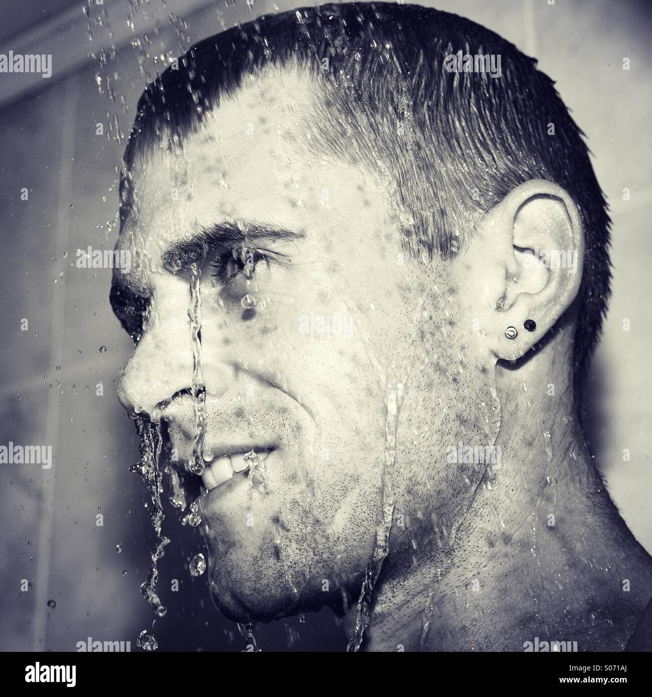 Happy guy in shower cooling down Stock Photo Alamy