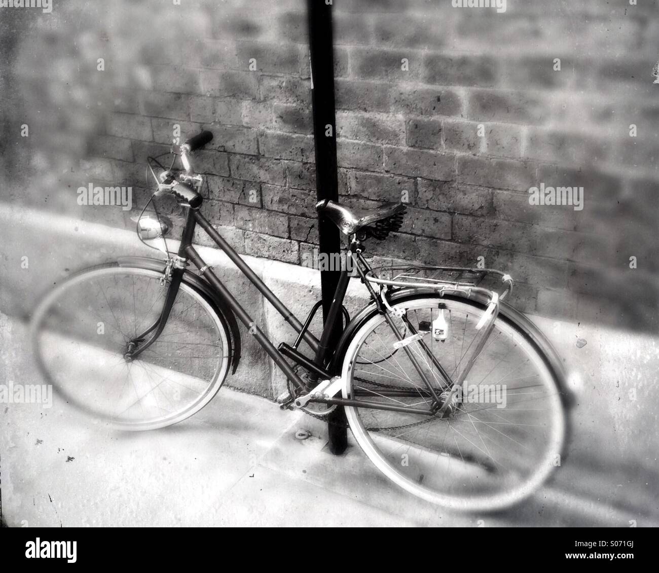 A old fashioned bicycle tied to a lamppost - Smartphone Captured Stock Image