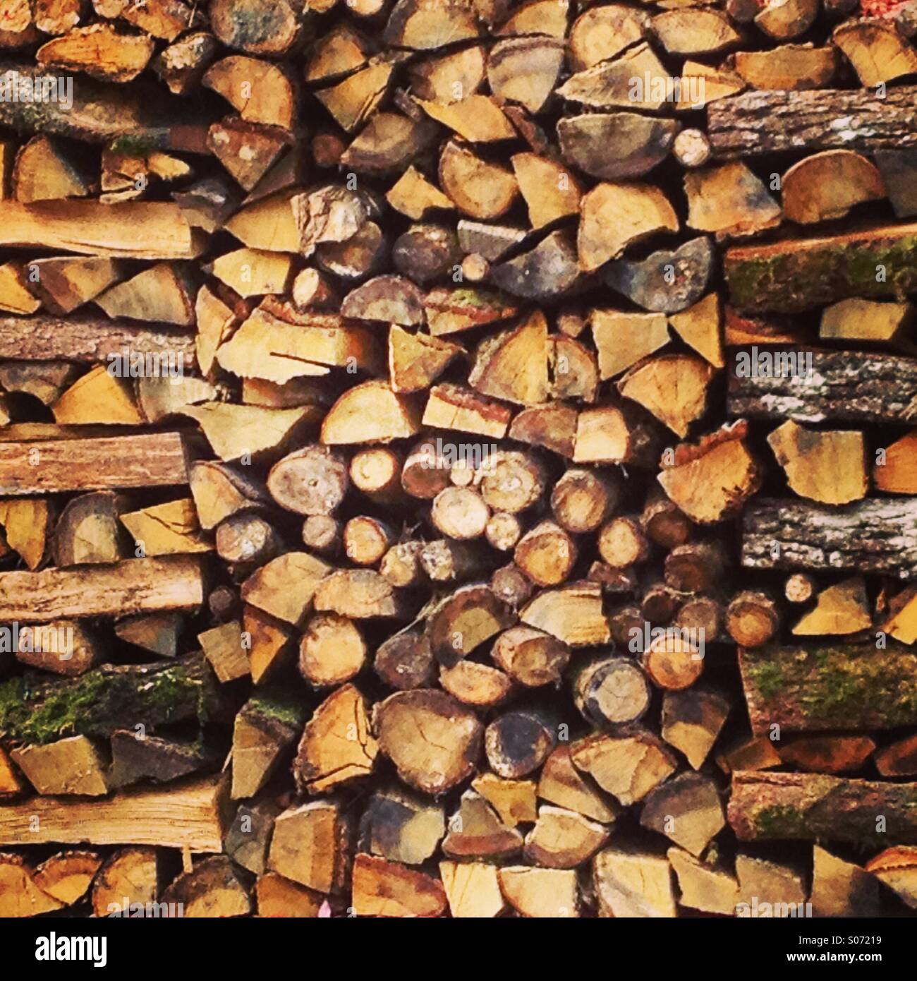 Carefully stacked neat full frame log pile background. Mobile phone photo with some phone or tablet post processing. - Smartphone Captured Stock Image