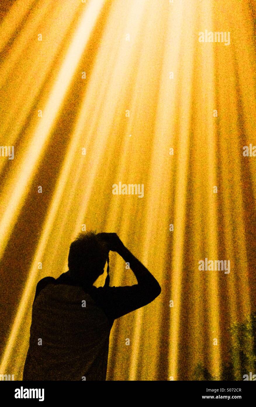 Silhouette of photographer photographing light show - Smartphone Captured Stock Image