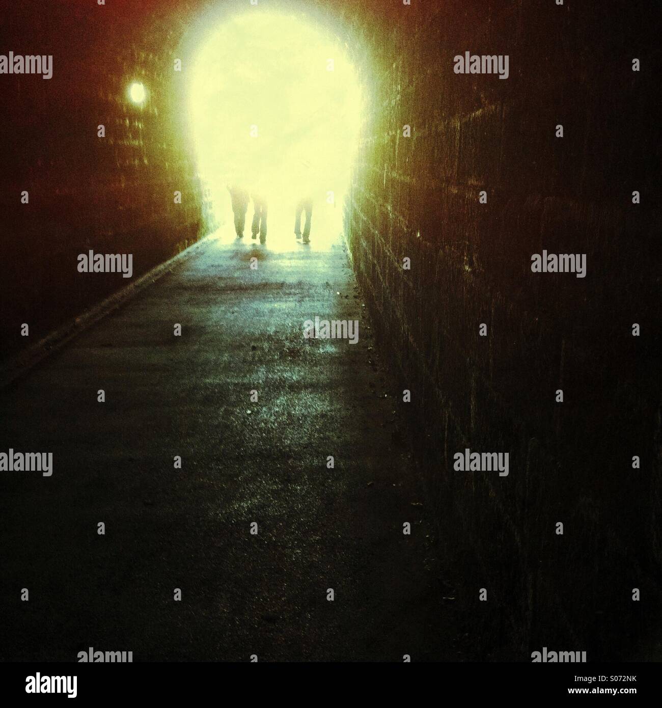 People walking into the light along a tunnel England UK Britain GB - Smartphone Captured Stock Image