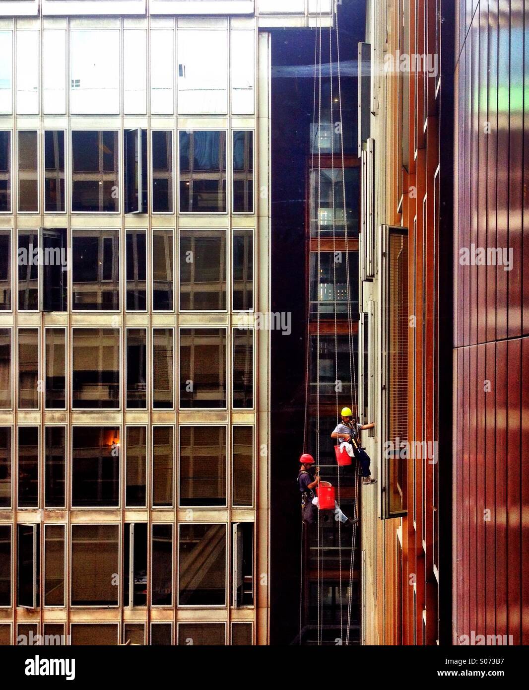 Workers cleaning glass wall - Smartphone Captured Stock Image