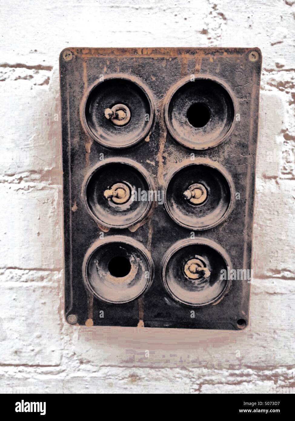 A switchboard on a white brick wall Stock Photo Alamy