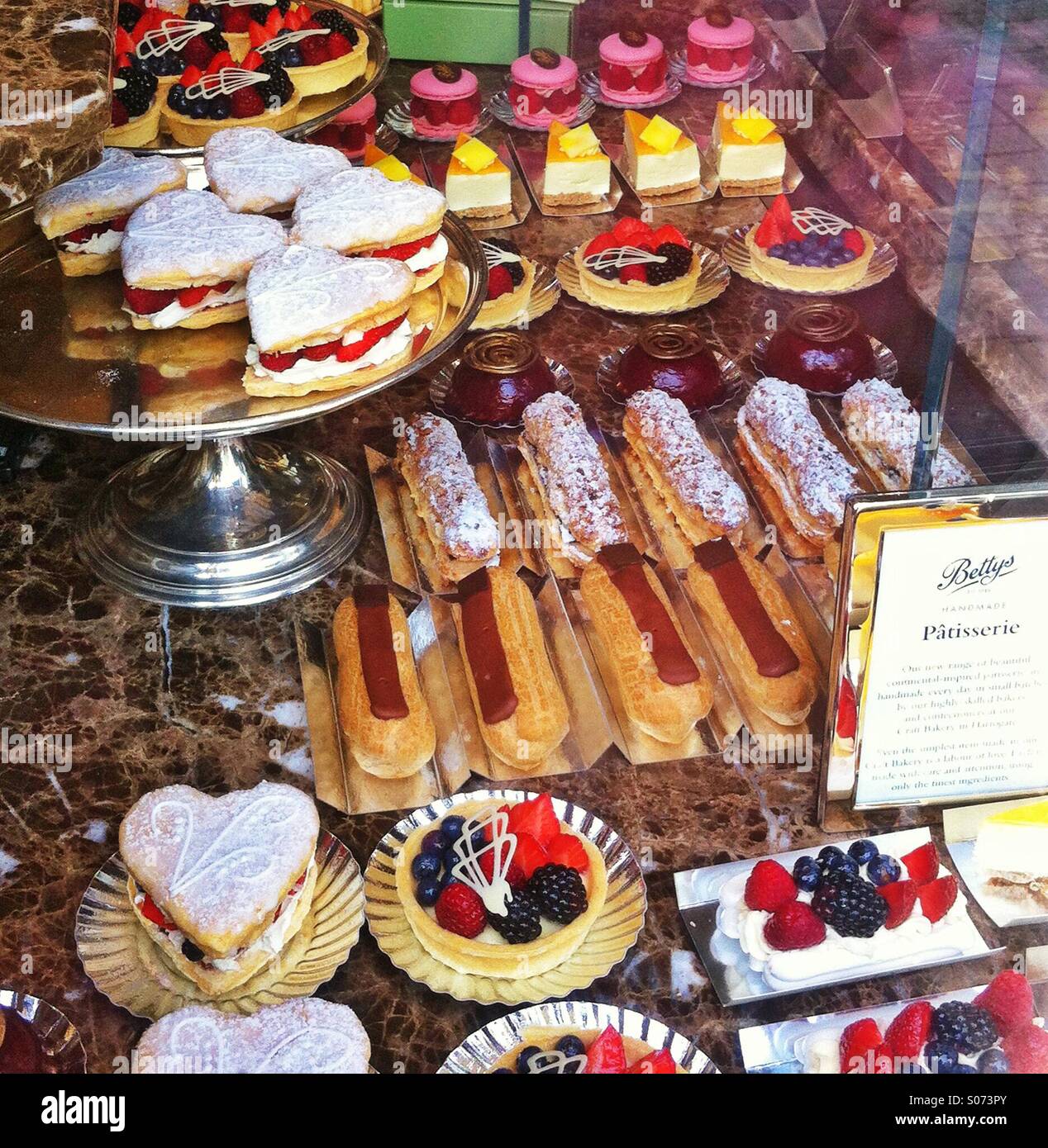 Cream cakes in a shop window York North Yorkshire England UK - Smartphone Captured Stock Image