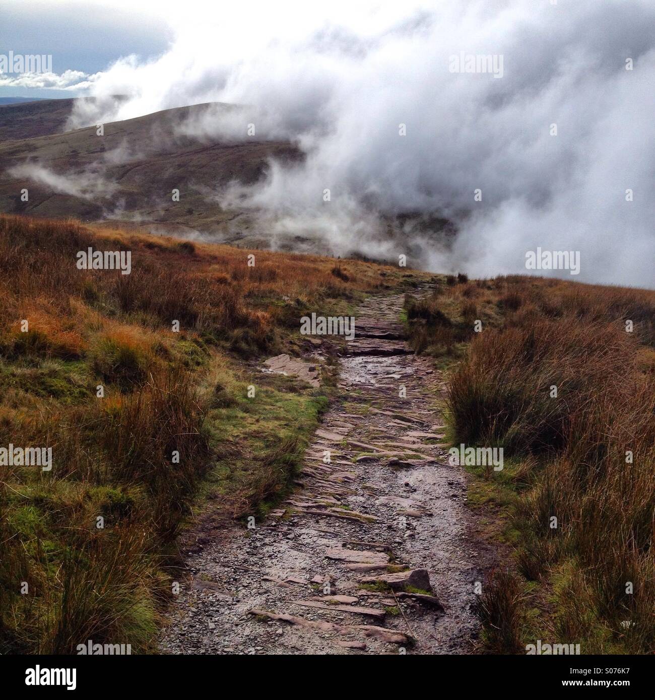 A mountain path through mist and cloud in the Brecon Beacons National Park in Wales Stock Photo