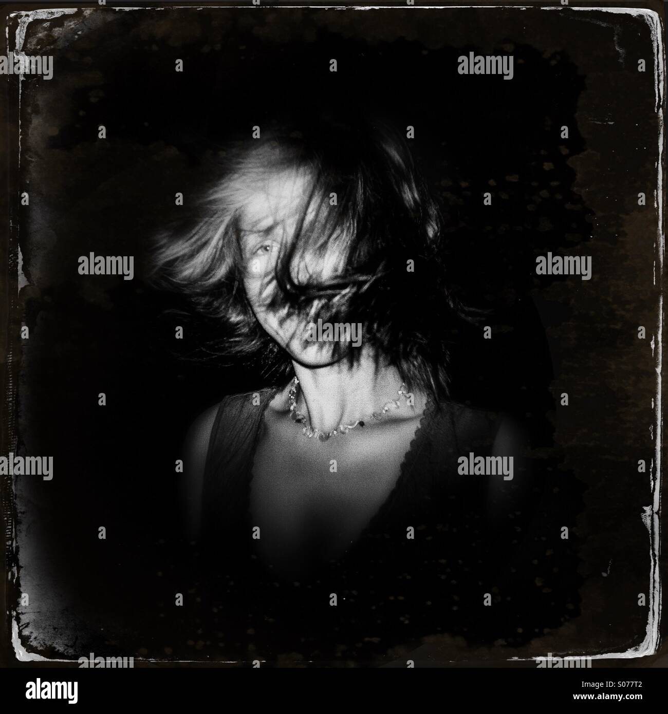 A women with hair blowing in wind - Smartphone Captured Stock Image