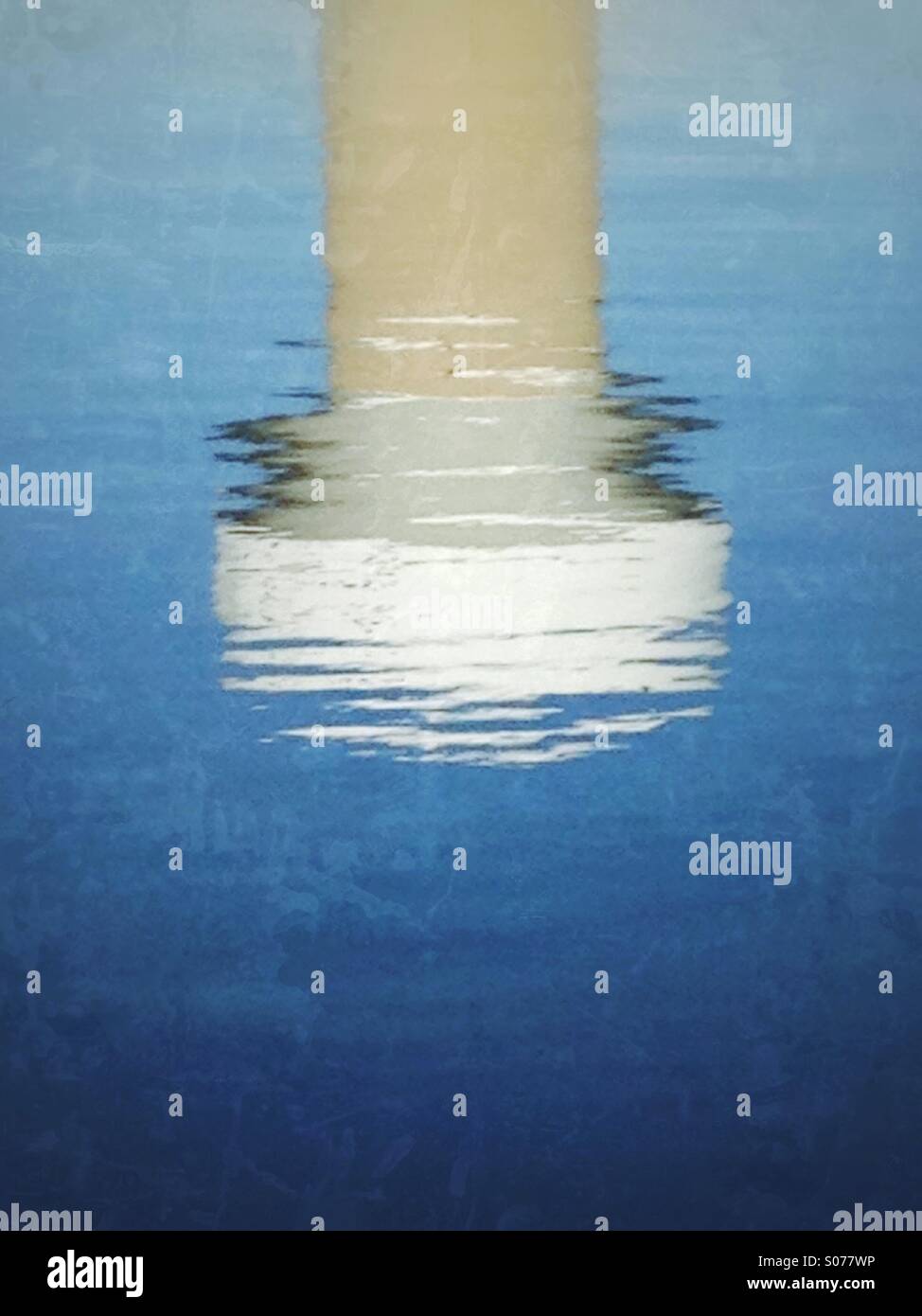 A rippling reflection of a water tower. - Smartphone Captured Stock Image