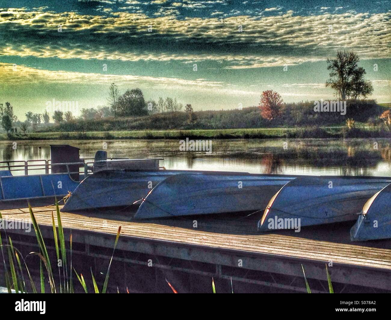 Canoes at sunrise on a dock. - Smartphone Captured Stock Image