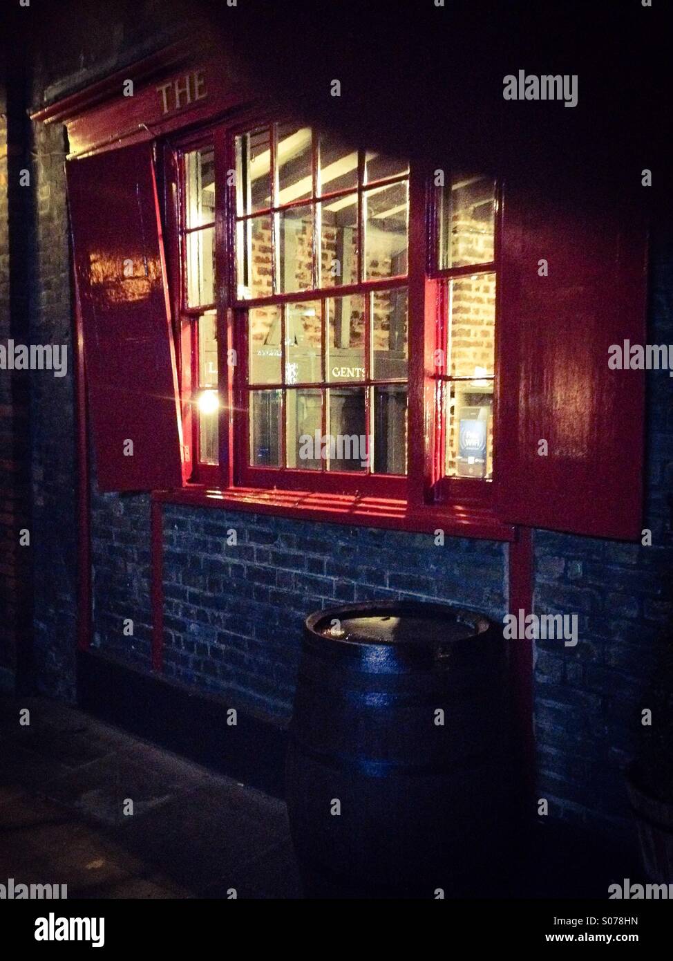 Night-time view looking through the window of an old London Pub near London Bridge, Southwark, London - Smartphone Captured Stock Image