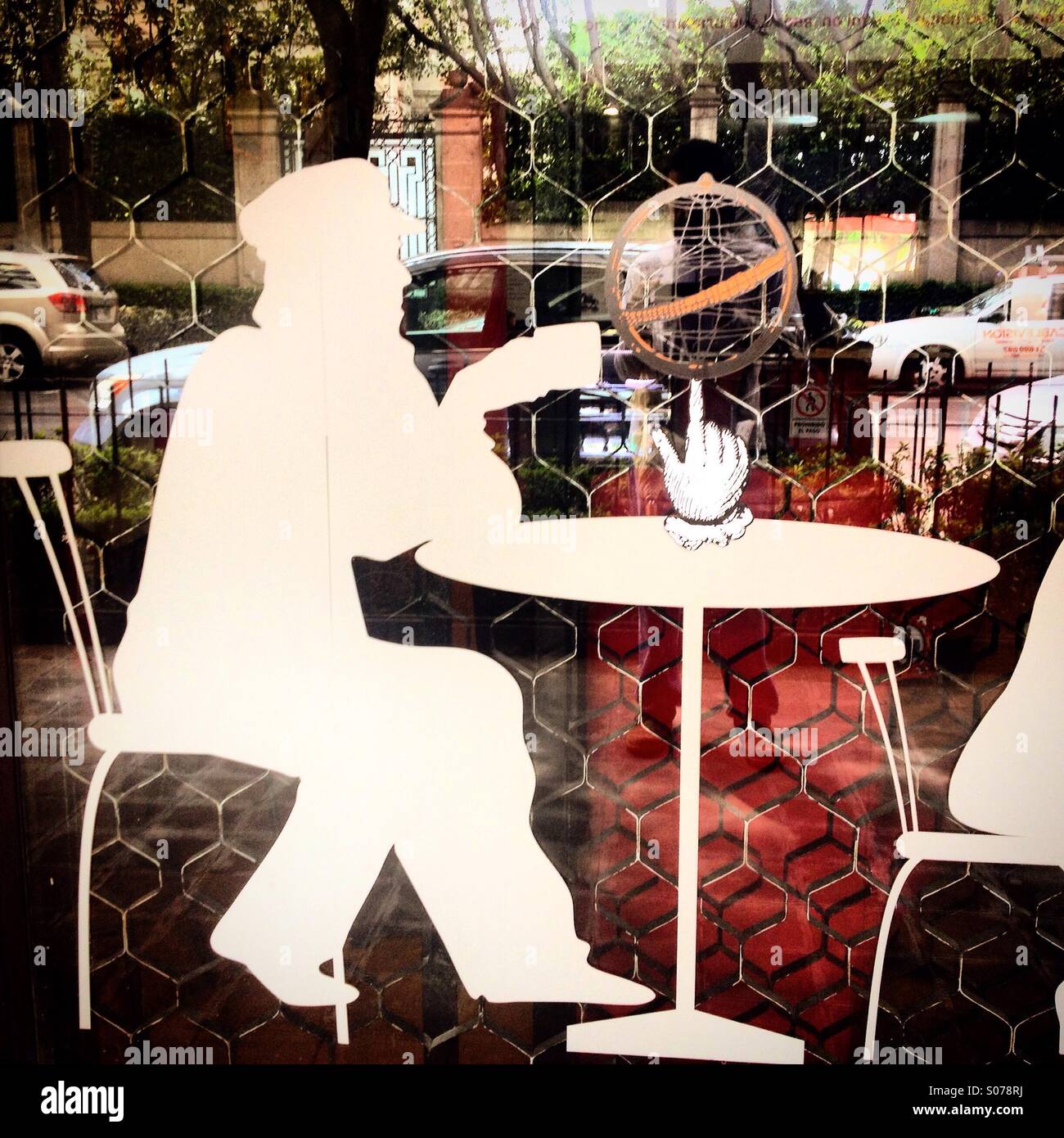 A white silhouette of a man having a cup of coffee decorates Secreto coffee shop in Mexico City, Mexico - Smartphone Captured Stock Image