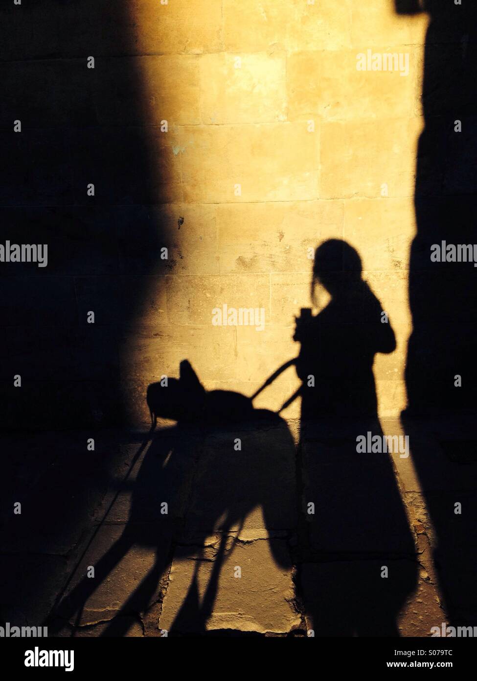 Shadow of a walking mama and his baby at sunset, Barcelona, Spain - Smartphone Captured Stock Image