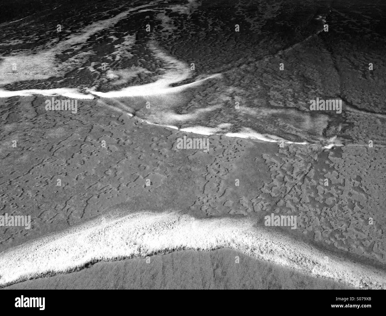 Water and foam on sand - Smartphone Captured Stock Image