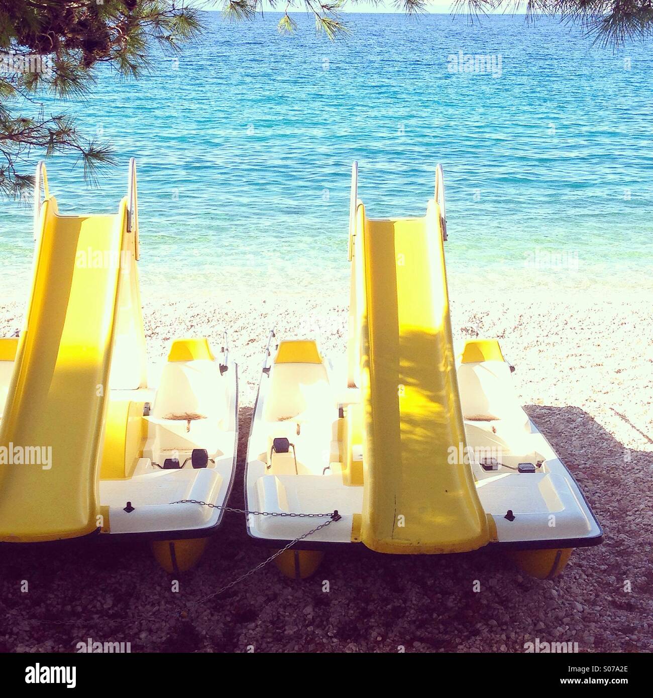 Two pedal boats at beach near blue sea Stock Photo Alamy