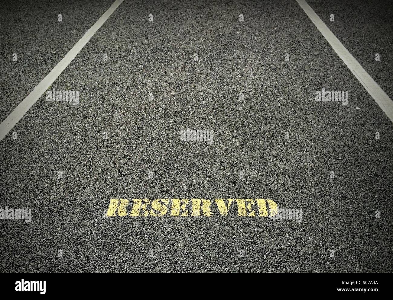 Parking space with reserved mark painted inside Stock Photo