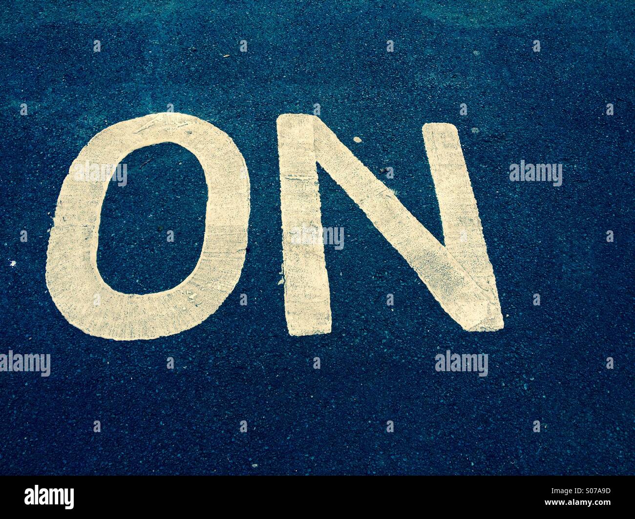 The word on painted on to Tarmac - Smartphone Captured Stock Image