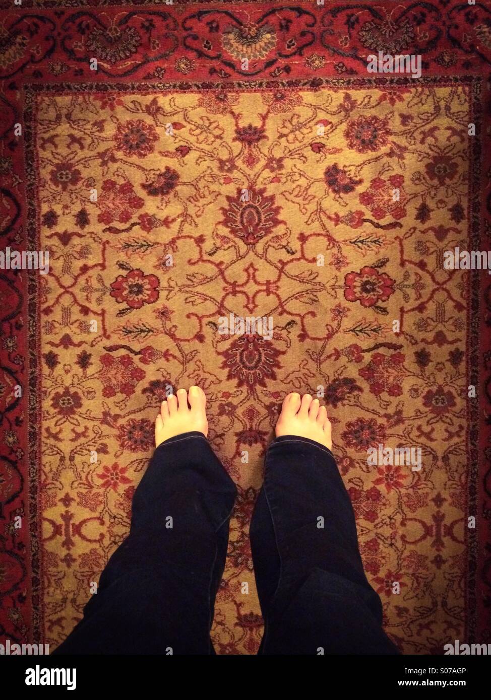 Bare feet on rug Stock Photo Alamy