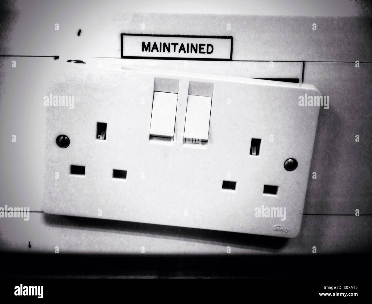 A 'maintained' 13amp plug socket that clearly is not maintained Stock Photo