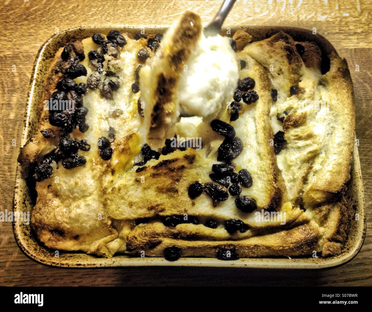 A spoonful of bread and butter pudding Stock Photo Alamy
