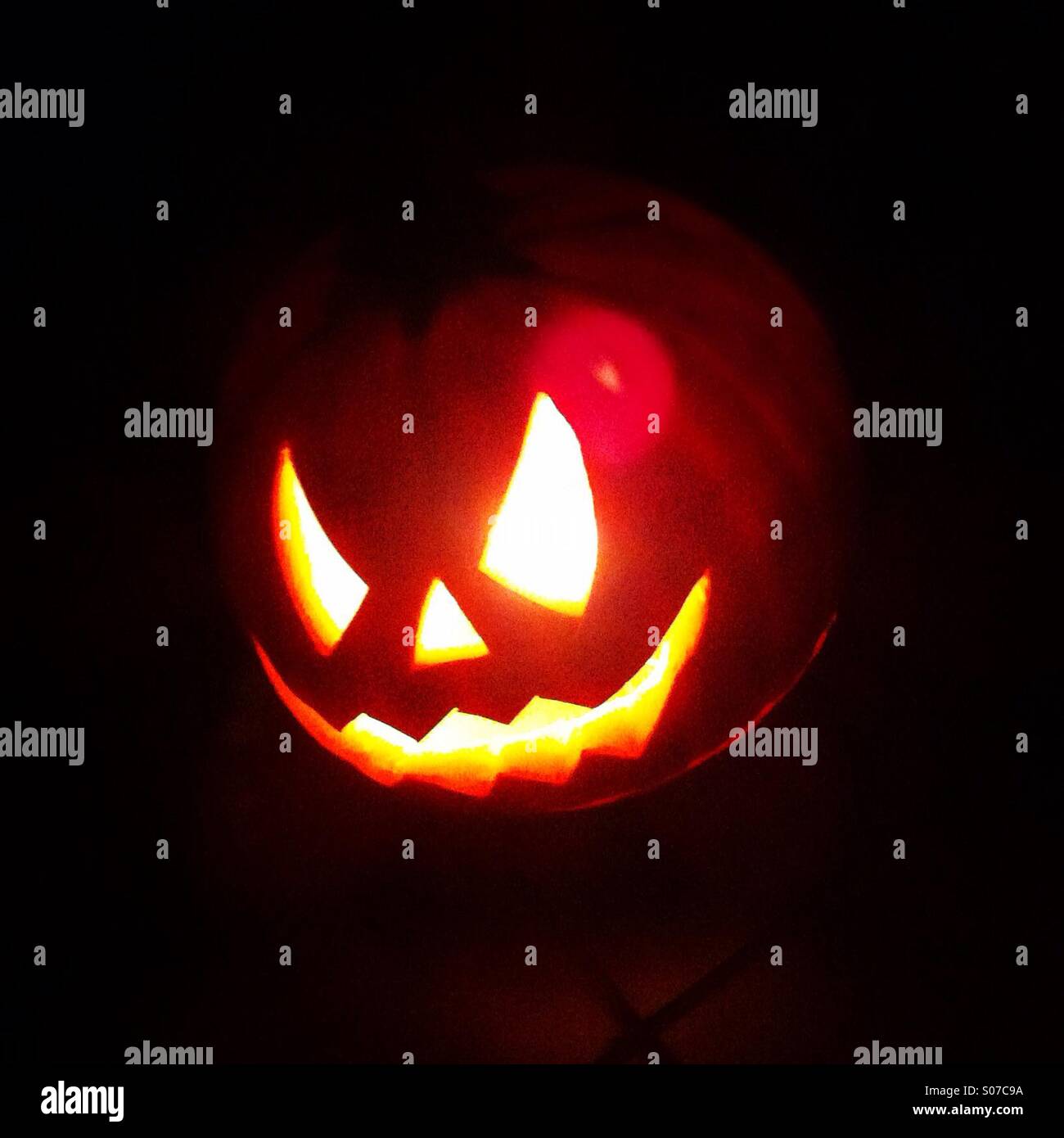 Glowing Halloween pumkin in the dark - Smartphone Captured Stock Image
