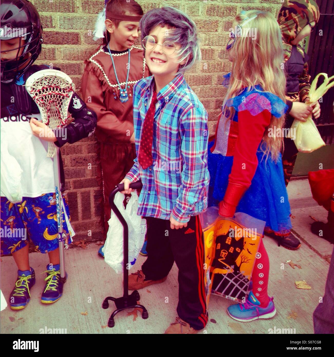Boy dressed as old man with cane for Halloween - Smartphone Captured Stock Image