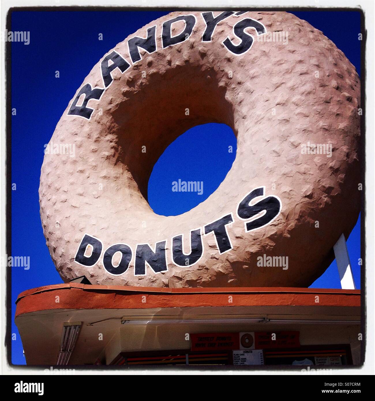 Giant donut on top of Randy's Donuts, a famous doughnut shop and bakery in Los Angeles, California, USA. Stock Photo