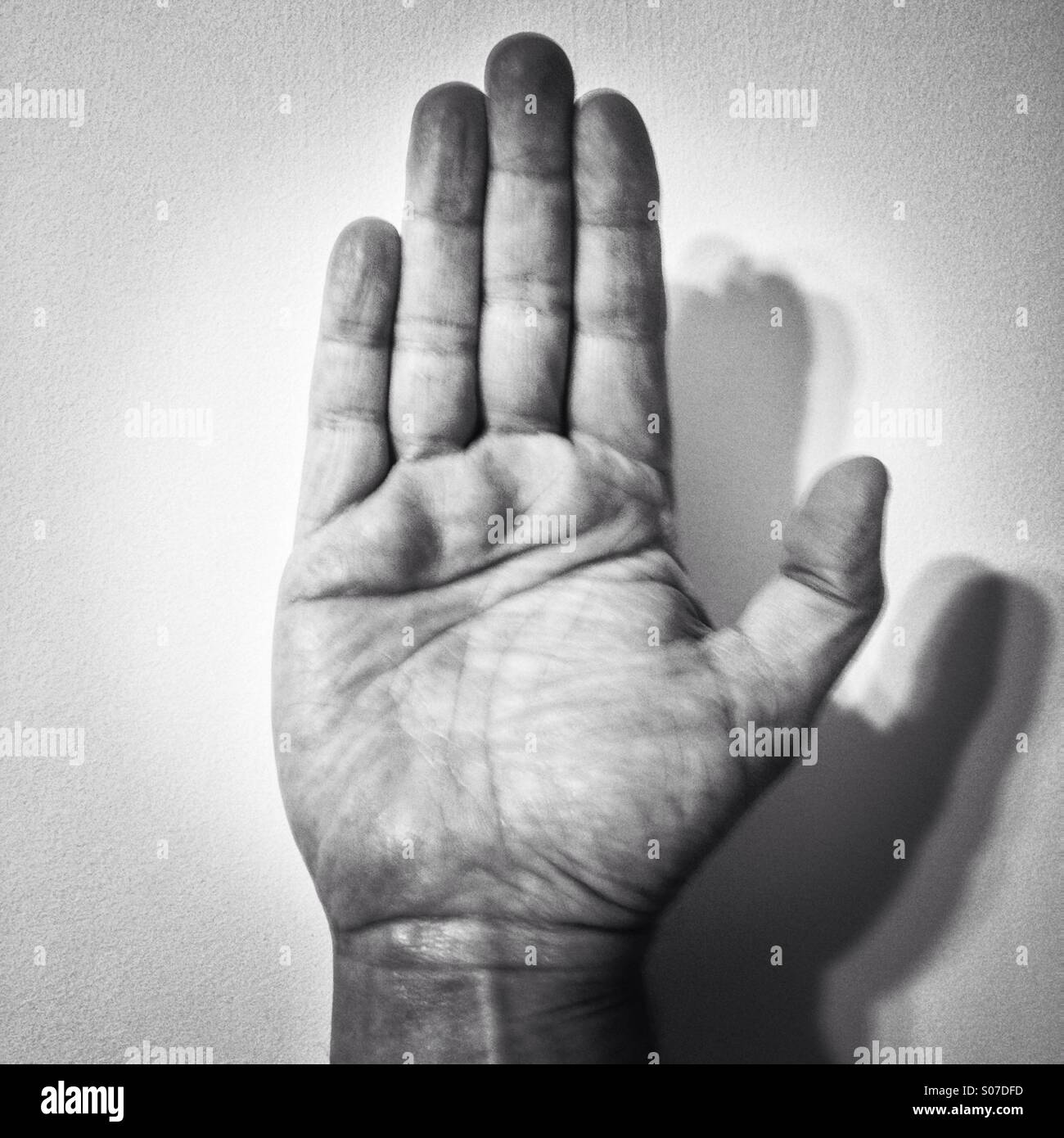 Raised right hand black and white Stock Photo