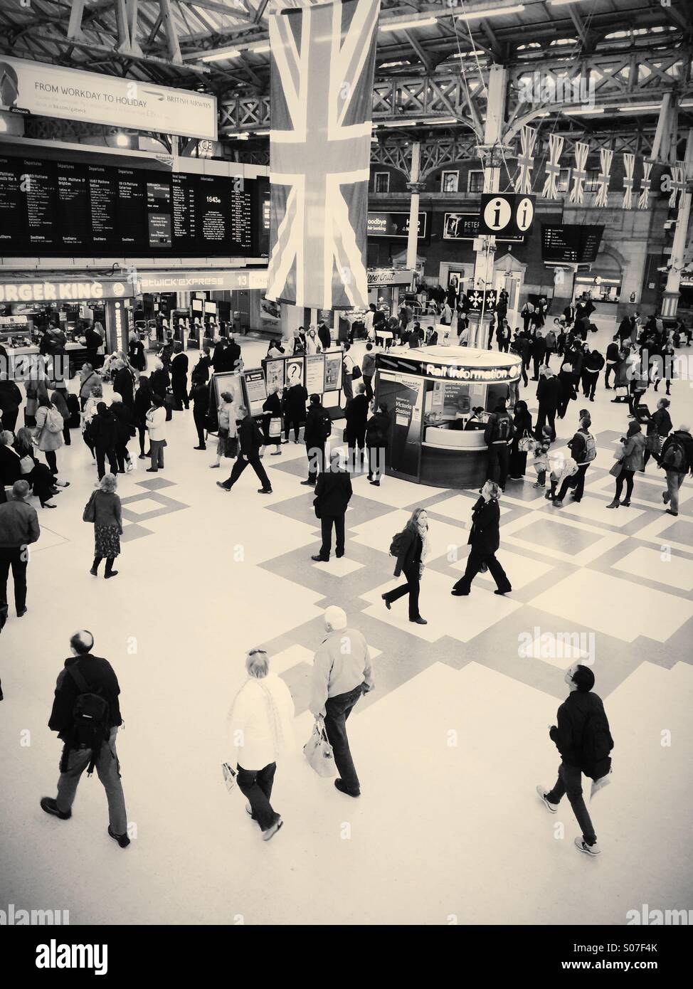 Travellers walking through mainline railway station - Smartphone Captured Stock Image