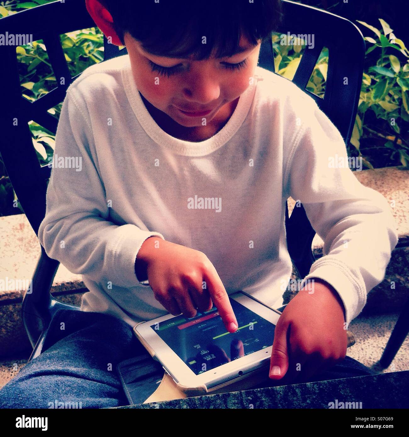 Kid playing tablet - Smartphone Captured Stock Image