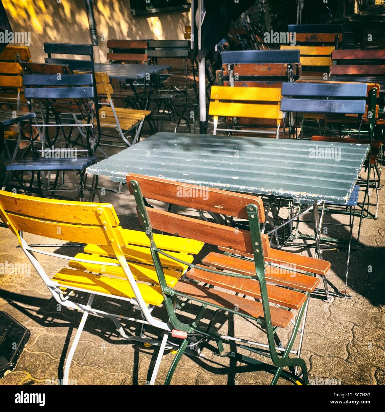 Colourful Painted Wooden Outdoor Table And Chairs Stock Photo